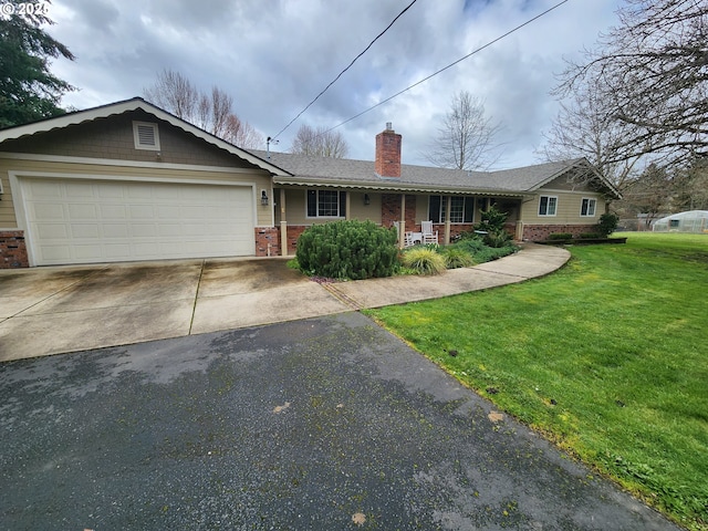 ranch-style house with aphalt driveway, a porch, brick siding, and a front yard