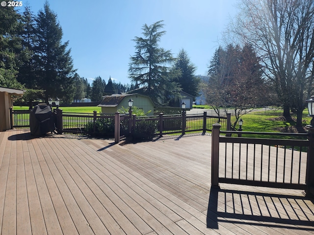 wooden terrace featuring a yard