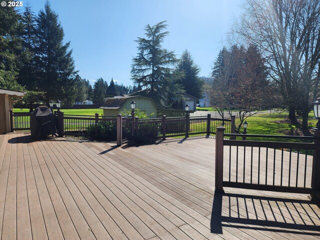 wooden deck with a lawn