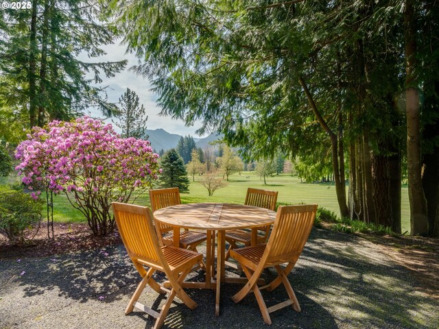 69070 E Fairway Ave, Welches, OR 97067 - view of patio / terrace featuring a mountain view and outdoor dining space