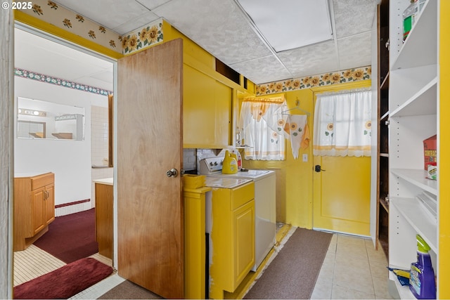 interior space featuring washer / dryer, light countertops, and light tile patterned floors