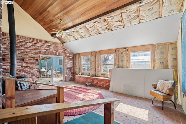 sunroom / solarium with wooden ceiling, vaulted ceiling, a wood stove, and ceiling fan