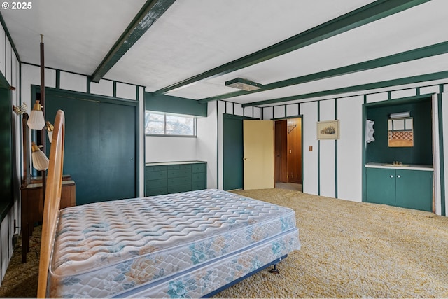 bedroom with carpet and beam ceiling