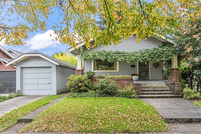 view of front facade with a front yard, a garage, and a porch