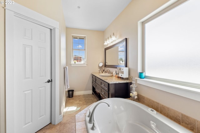 bathroom featuring a tub, tile floors, and vanity