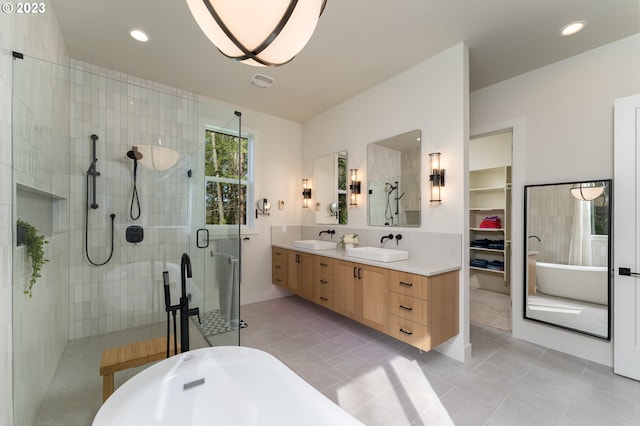 bathroom with plus walk in shower, tile flooring, and double vanity