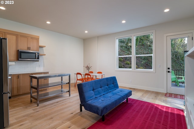 sitting room featuring light wood-type flooring and plenty of natural light