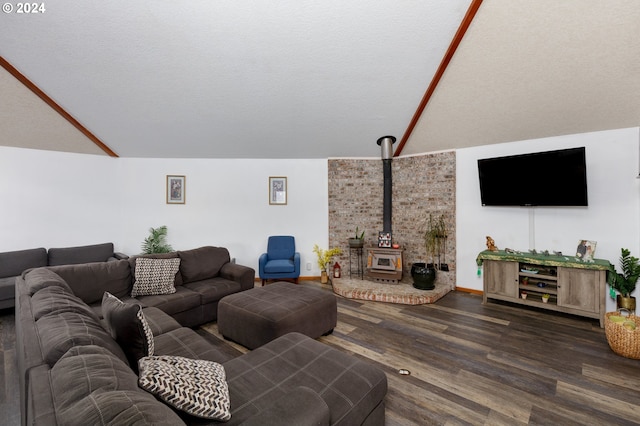 living room with a textured ceiling, vaulted ceiling, dark hardwood / wood-style floors, and a wood stove