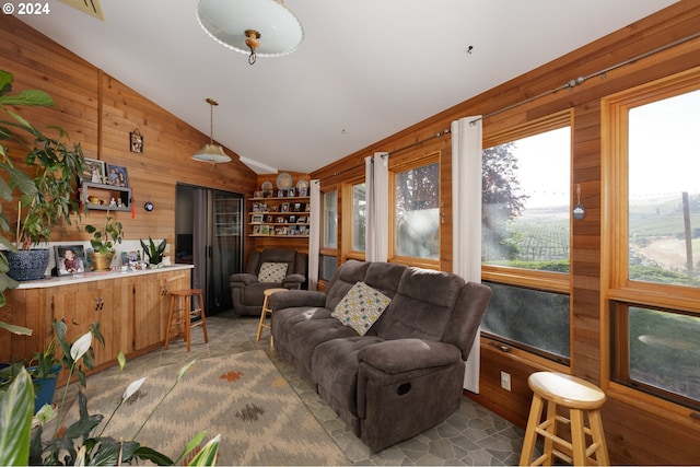 living room featuring wooden walls and high vaulted ceiling