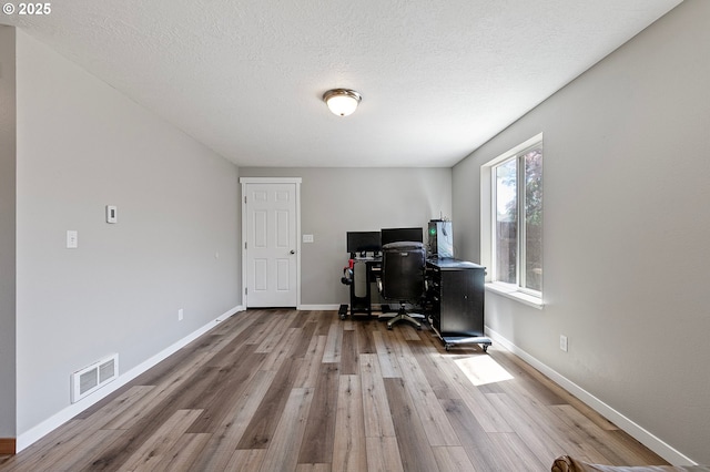 1062 Applegate Pl, Harrisburg, OR 97446 - office featuring wood finished floors, baseboards, and a textured ceiling