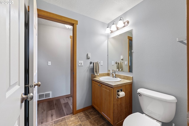 1062 Applegate Pl, Harrisburg, OR 97446 - bathroom with vanity, toilet, a textured ceiling, and french doors