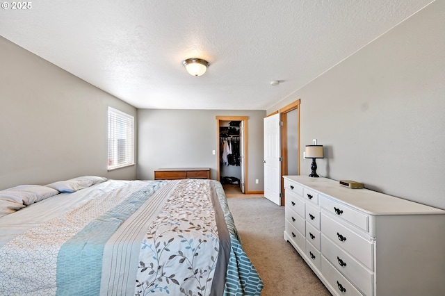 1062 Applegate Pl, Harrisburg, OR 97446 - bedroom featuring light colored carpet, a textured ceiling, a walk in closet, and a closet