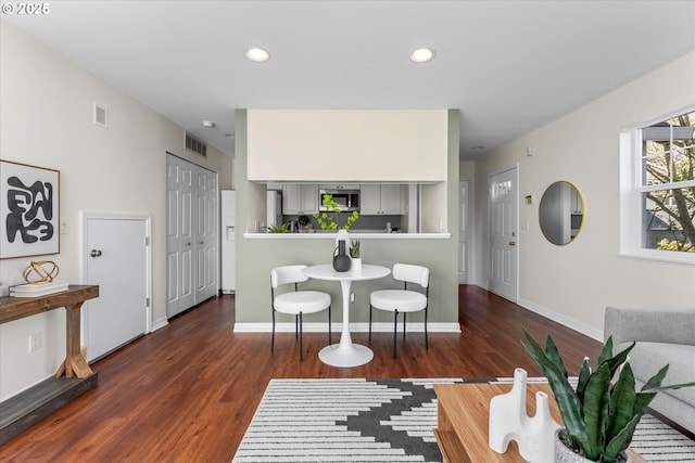 living area featuring wood finished floors, visible vents, and recessed lighting
