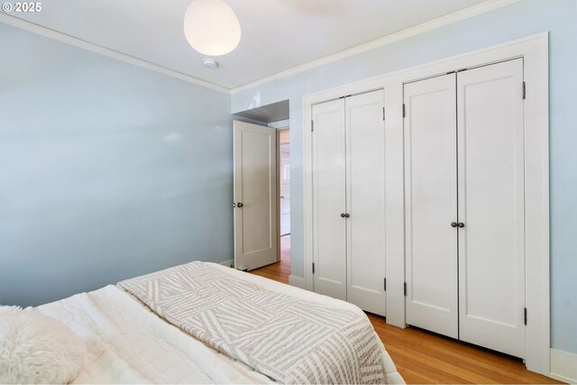 1403 SE Birch St, Portland, OR 97214 - bedroom with crown molding, wood finished floors, and two closets