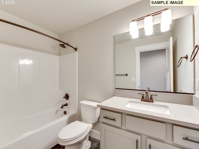 full bathroom featuring shower / bathing tub combination, toilet, large vanity, and a textured ceiling