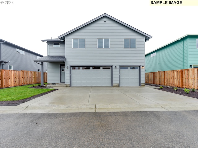 view of property with a front yard and a garage