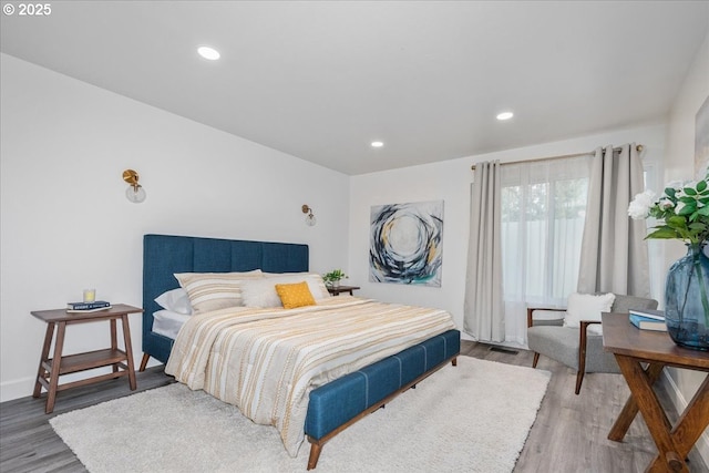 bedroom featuring recessed lighting, wood finished floors, and baseboards