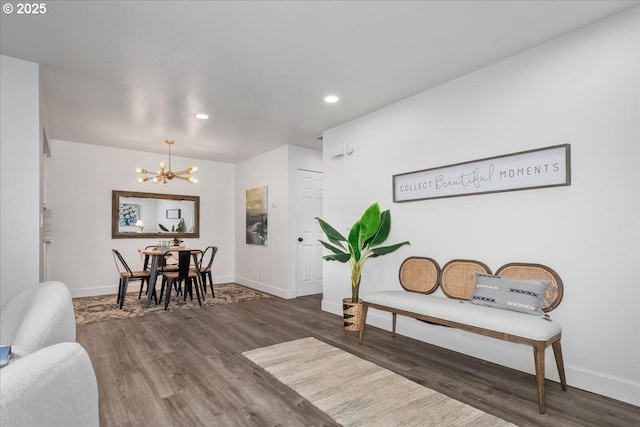 interior space with recessed lighting, a notable chandelier, wood finished floors, and baseboards