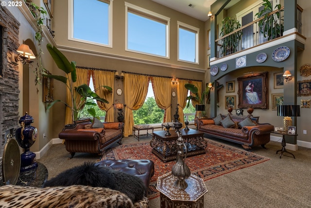 living room with carpet floors and a high ceiling