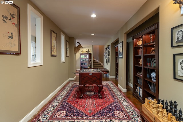 corridor featuring dark hardwood / wood-style flooring