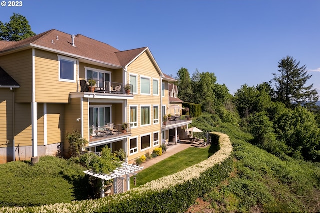 rear view of property with a balcony