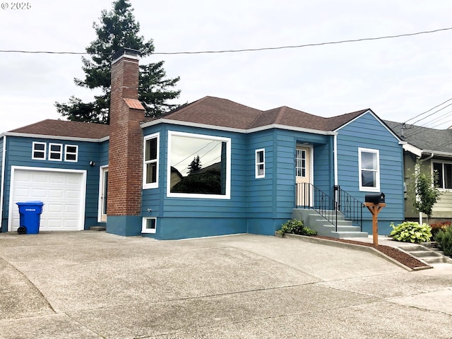 703 Cowlitz Way, Kelso, WA 98626 - view of front of property featuring a chimney, driveway, an attached garage, and roof with shingles