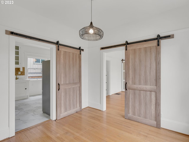 tiled spare room with a barn door