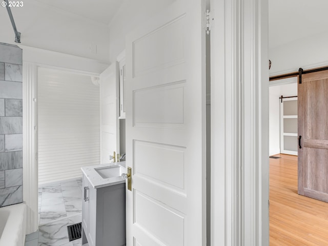 bathroom with shower / tub combination, hardwood / wood-style floors, and vanity