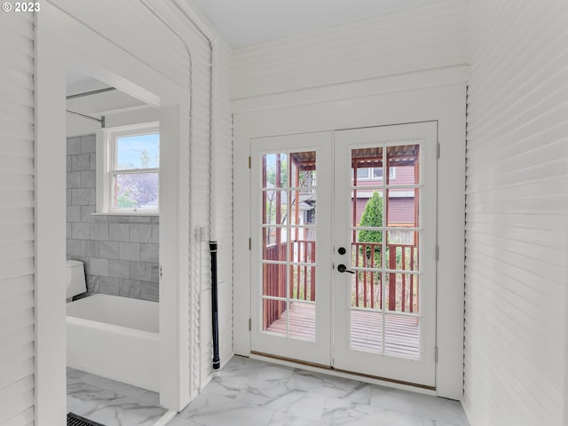 doorway to outside featuring light tile floors and french doors