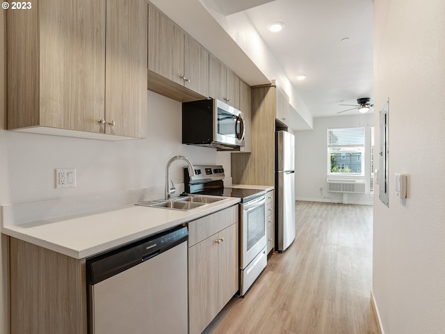 4738 SE Belmont St, Portland, OR 97215 - kitchen featuring appliances with stainless steel finishes, light brown cabinetry, ceiling fan, light hardwood / wood-style floors, and sink
