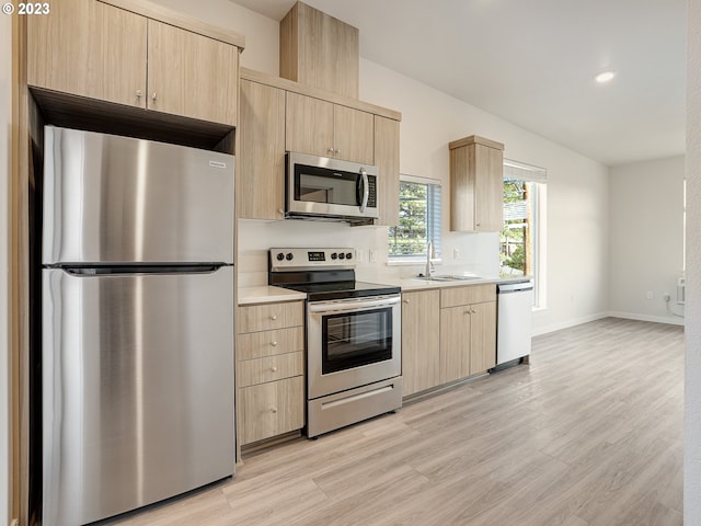 4738 SE Belmont St, Portland, OR 97215 - kitchen with sink, light hardwood / wood-style floors, light brown cabinetry, and stainless steel appliances