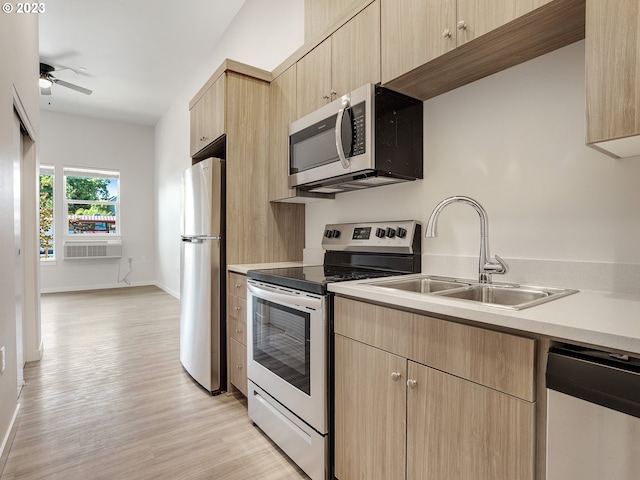 4738 SE Belmont St, Portland, OR 97215 - kitchen featuring ceiling fan, appliances with stainless steel finishes, light brown cabinets, sink, and light hardwood / wood-style flooring