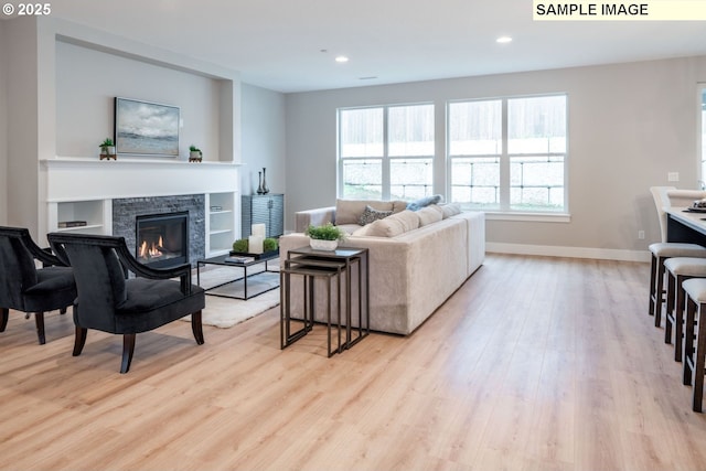 1103 S Mountain Pl, Ridgefield, WA 98642 - living room featuring light wood-style flooring, a glass covered fireplace, and recessed lighting