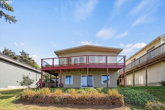rear view of property featuring a wooden deck