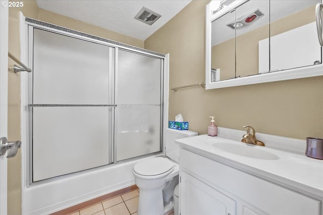 full bathroom featuring tile patterned floors, toilet, shower / bath combination with glass door, and vanity