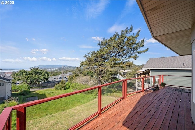 wooden deck with a lawn and a mountain view