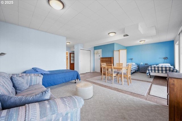 tiled bedroom featuring carpet floors