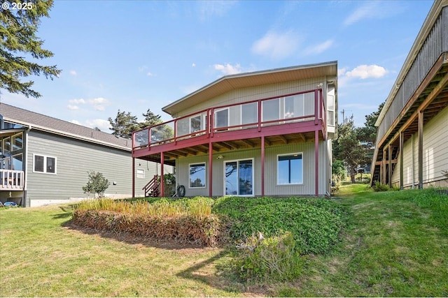 back of house featuring a yard and a wooden deck