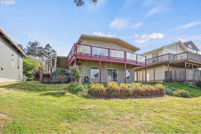 back of house featuring a lawn and a deck