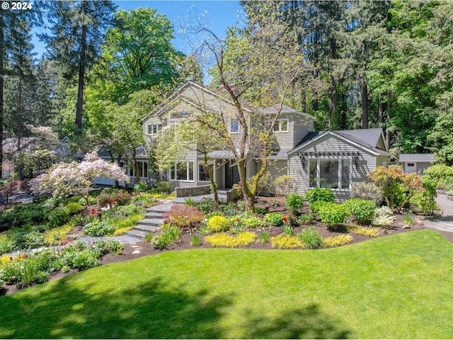 back of house with a yard and a pergola