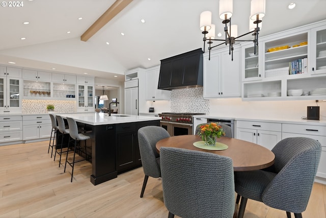 kitchen with premium range hood, high quality appliances, a notable chandelier, open shelves, and light countertops