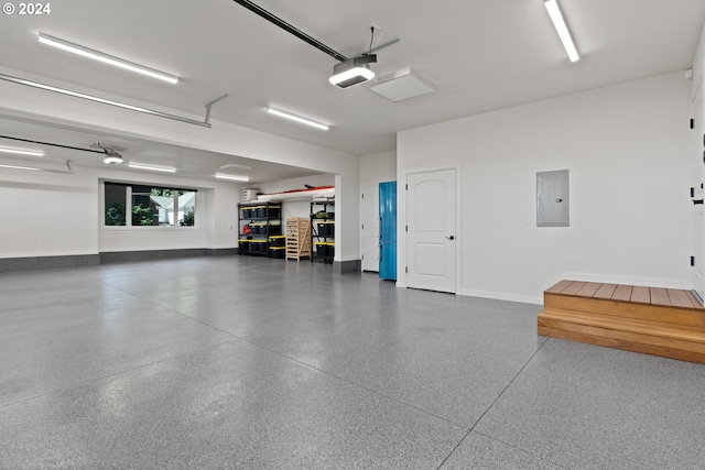 garage featuring electric panel, a garage door opener, and baseboards