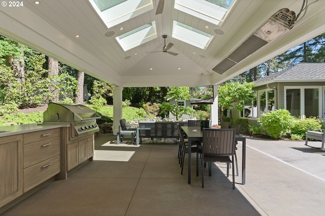 view of patio / terrace with outdoor dining area, an outdoor kitchen, and grilling area