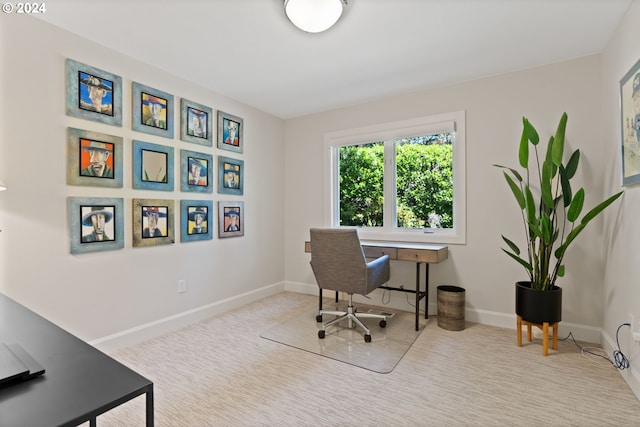 carpeted office featuring baseboards