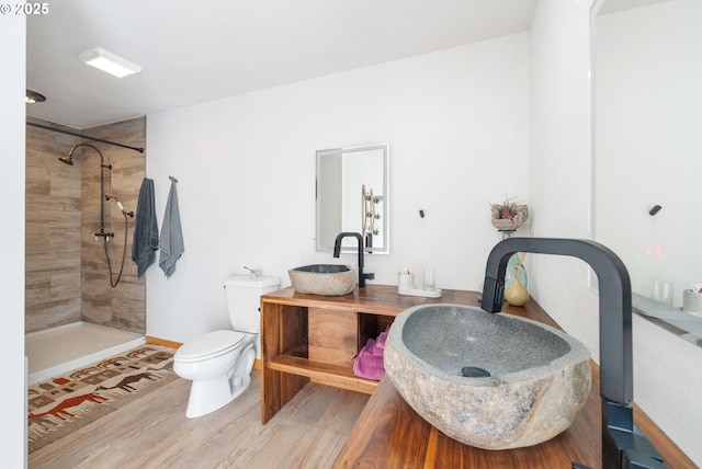53310 Morrison Rd, Bandon, OR 97411 - bathroom with a tile shower, double vanity, and wood finished floors