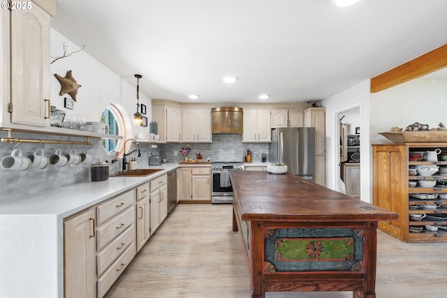 53310 Morrison Rd, Bandon, OR 97411 - kitchen featuring stainless steel appliances, wall chimney exhaust hood, light wood finished floors, backsplash, and recessed lighting