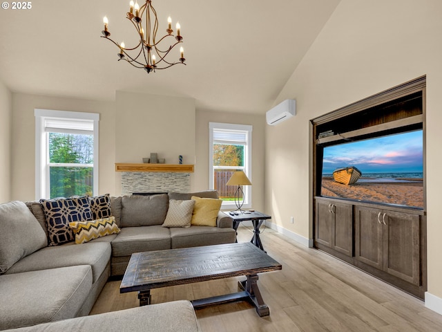 293 W Kershul Cir, Gearhart, OR 97138 - living room with a wall mounted air conditioner, light wood finished floors, a chandelier, lofted ceiling, and a stone fireplace