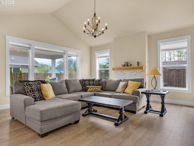 293 W Kershul Cir, Gearhart, OR 97138 - living room with a chandelier, healthy amount of natural light, light wood-type flooring, and lofted ceiling