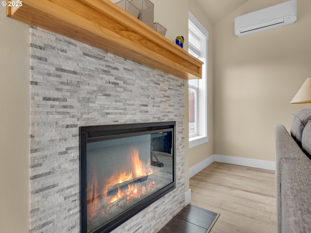 293 W Kershul Cir, Gearhart, OR 97138 - detailed view of a wall mounted air conditioner, a glass covered fireplace, and wood finished floors