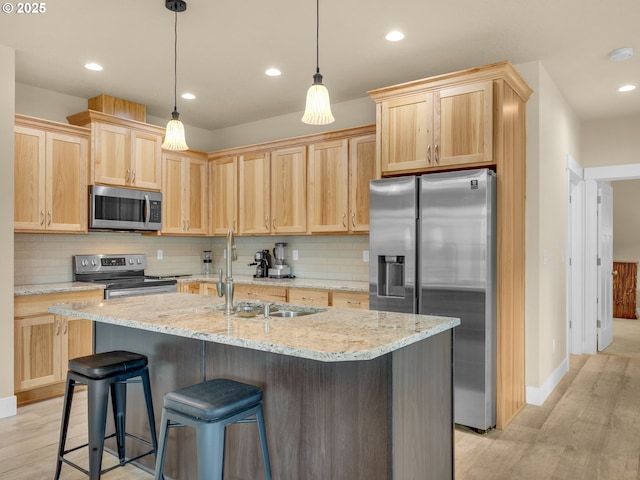 293 W Kershul Cir, Gearhart, OR 97138 - kitchen with stainless steel appliances, light brown cabinets, light wood finished floors, backsplash, and recessed lighting
